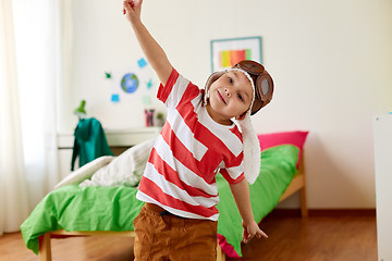 Image showing happy little boy in pilot hat playing at home