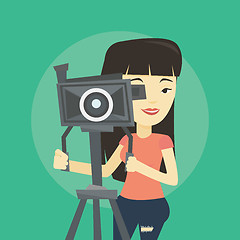 Image showing Cameraman with movie camera on tripod.