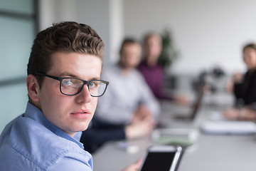 Image showing Businessman using tablet in modern office