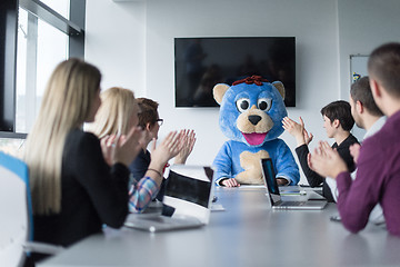 Image showing boss dresed as bear having fun with business people in trendy of