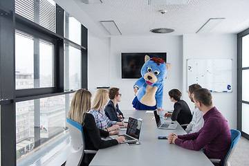 Image showing boss dresed as bear having fun with business people in trendy of