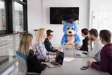 Image showing boss dresed as bear having fun with business people in trendy of