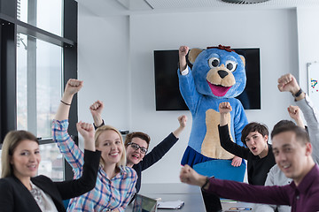 Image showing boss dresed as bear having fun with business people in trendy of