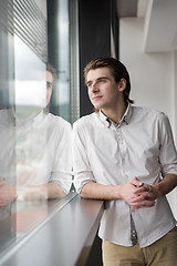 Image showing young businessman in startup office by the window