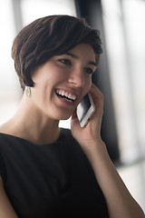 Image showing Elegant Woman Using Mobile Phone in office building