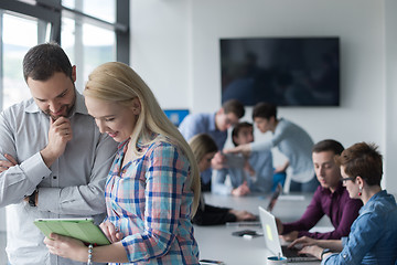 Image showing Two Business People Working With Tablet in office