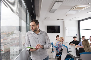 Image showing Businessman Using Tablet In Office Building by window