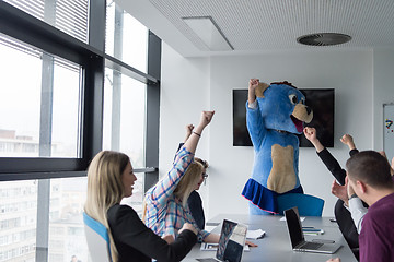 Image showing boss dresed as bear having fun with business people in trendy of