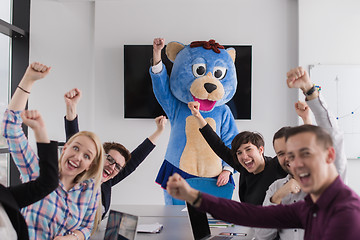 Image showing boss dresed as bear having fun with business people in trendy of