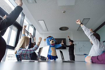 Image showing boss dresed as bear having fun with business people in trendy of