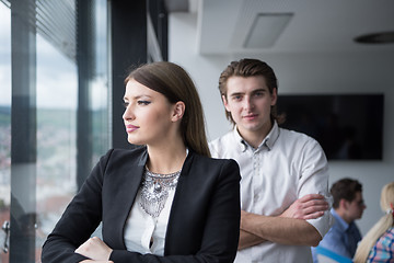 Image showing Elegant Woman Using Mobile Phone by window in office building