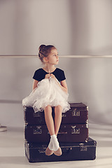 Image showing The little girl as balerina dancer sitting at studio