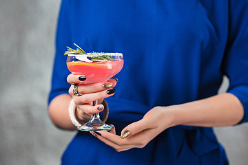 Image showing The exotic cocktail and female hands