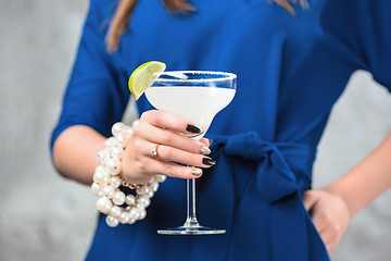 Image showing The exotic cocktail and female hands