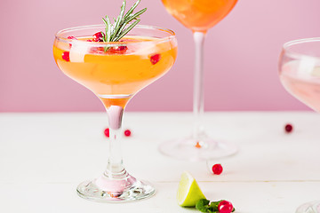 Image showing The rose exotic cocktails and fruits on pink