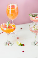 Image showing The rose exotic cocktails and fruits on pink