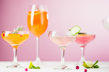 Image showing The rose exotic cocktails and fruits on pink