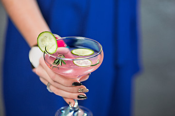 Image showing The exotic cocktail and female hands