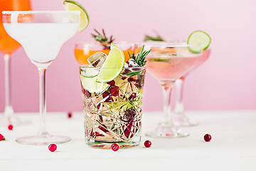 Image showing The rose exotic cocktails and fruits on pink