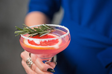 Image showing The exotic cocktail and female hands