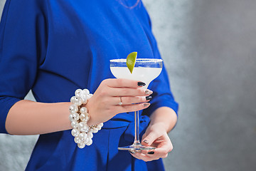 Image showing The exotic cocktail and female hands