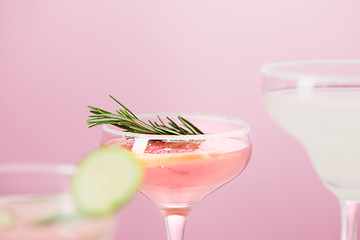 Image showing The rose exotic cocktails and fruits on pink