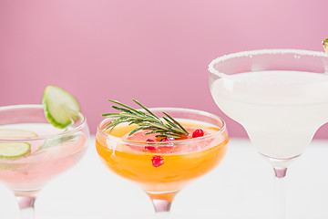 Image showing The rose exotic cocktails and fruits on pink