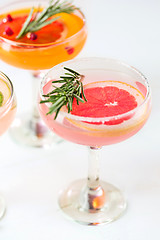 Image showing The rose exotic cocktails and fruits on pink