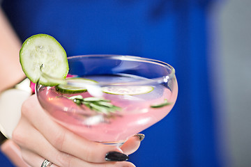 Image showing The exotic cocktail and female hands