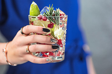 Image showing The exotic cocktail and female hands
