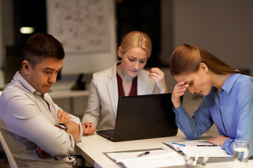 Image showing business team with laptop working late at office
