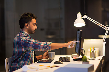 Image showing creative man with computer working at night office