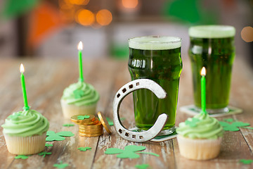 Image showing glasses of beer, cupcakes, horseshoe and coins