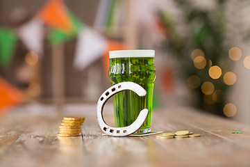 Image showing glass of green beer, horseshoe and gold coins