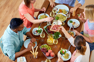 Image showing group of people eating at table with food