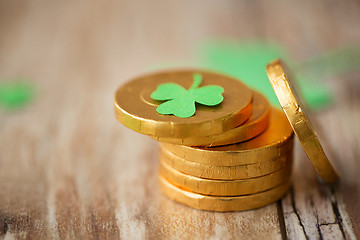 Image showing gold coins with shamrock on wooden table