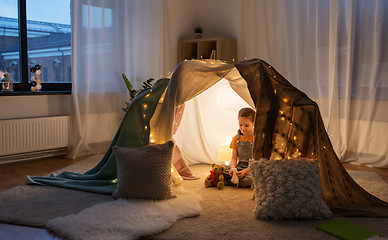 Image showing little girl with toys in kids tent at home