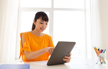 Image showing asian student girl with tablet pc learning at home