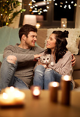 Image showing happy couple with cat at home