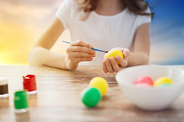 Image showing close up of girl coloring easter eggs 