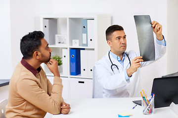 Image showing doctor with x-ray and male patient at clinic