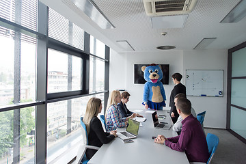 Image showing boss dresed as bear having fun with business people in trendy of