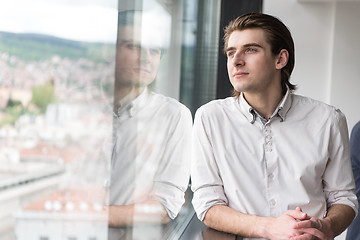 Image showing young businessman in startup office by the window