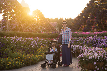 Image showing mother and daughter in flower garden