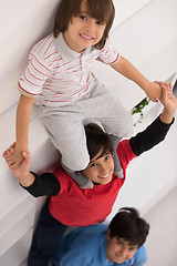 Image showing young boys posing line up piggyback top view