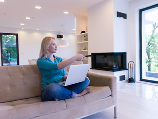 Image showing Young woman using laptop at home