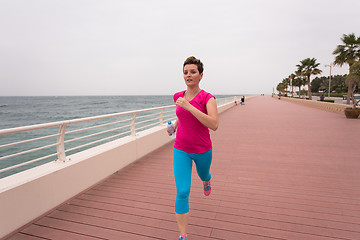 Image showing woman busy running on the promenade