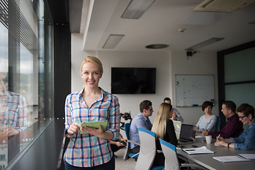 Image showing Pretty Businesswoman Using Tablet In Office Building by window