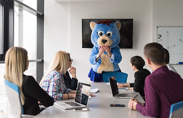 Image showing boss dresed as bear having fun with business people in trendy of