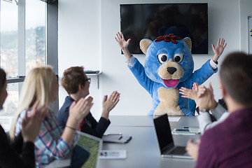 Image showing boss dresed as bear having fun with business people in trendy of